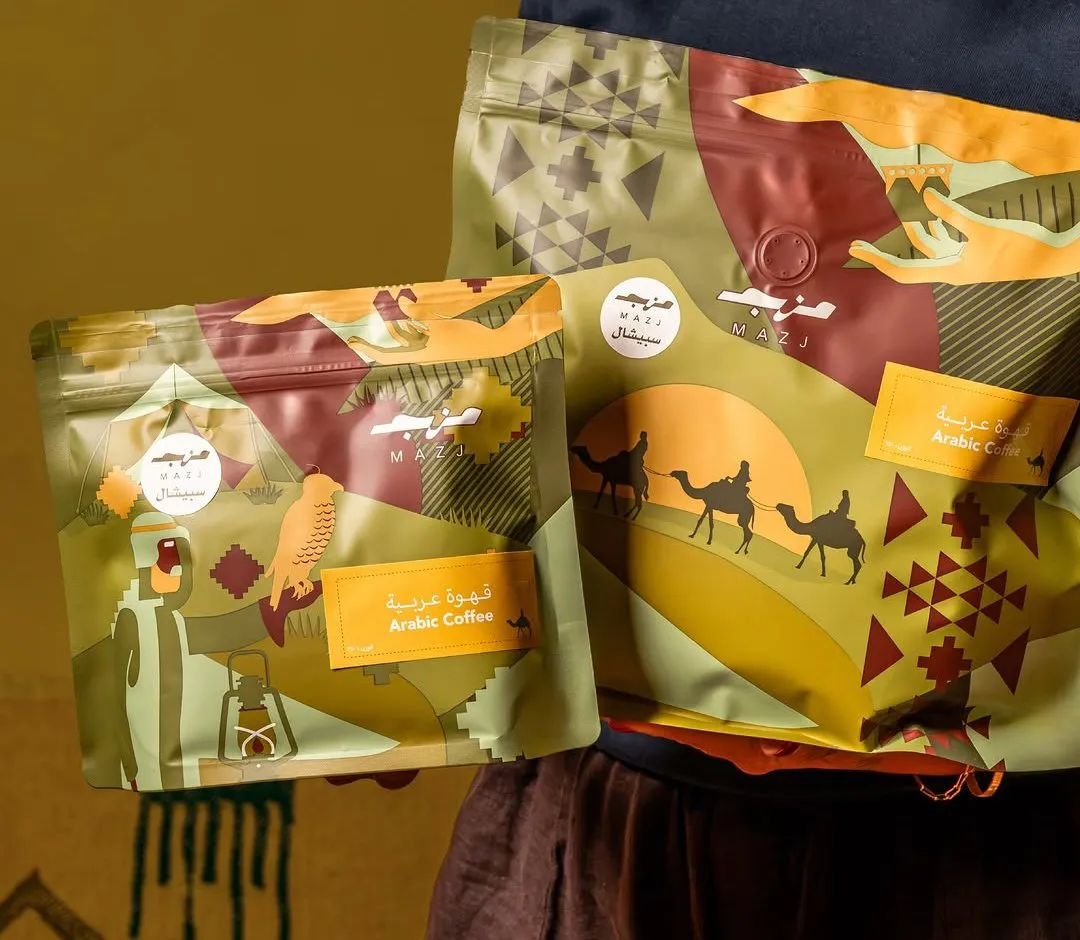 Two Mazj Arabic Coffee bags, small and large, with olive, ochre and wine artwork of camels and tents